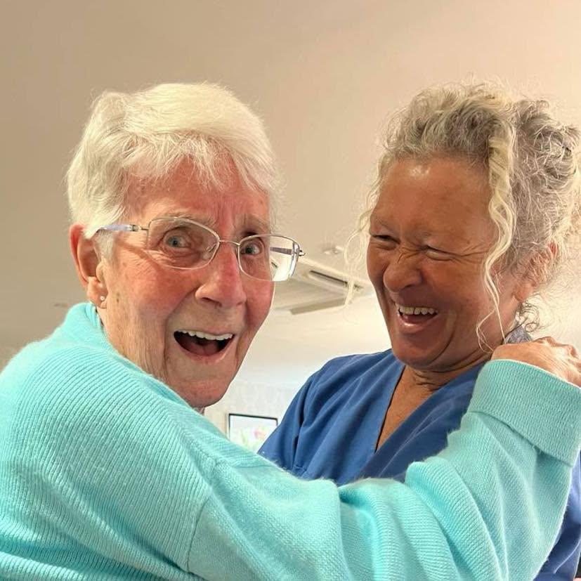 resident dancing with a staff member