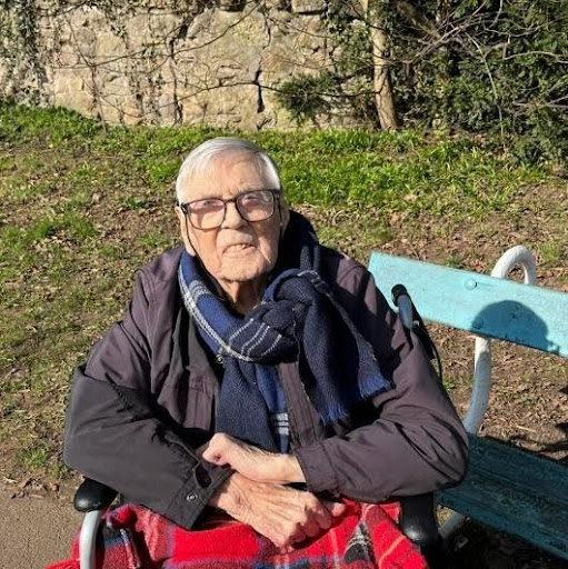 resident outdoors on bench