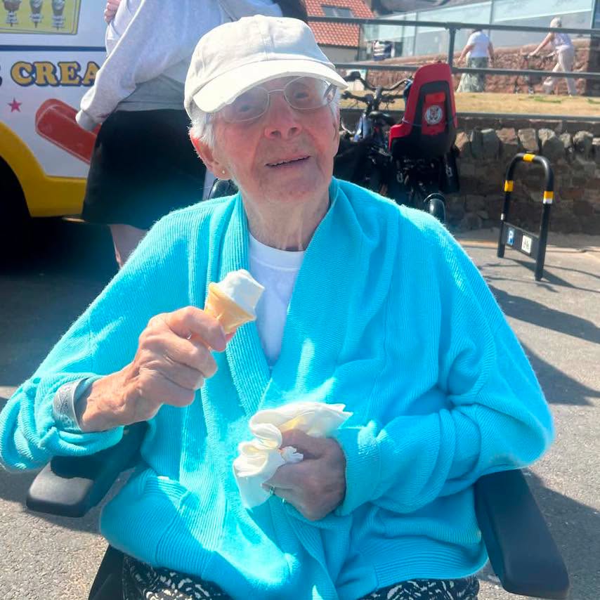 elderly woman eating an ice cream