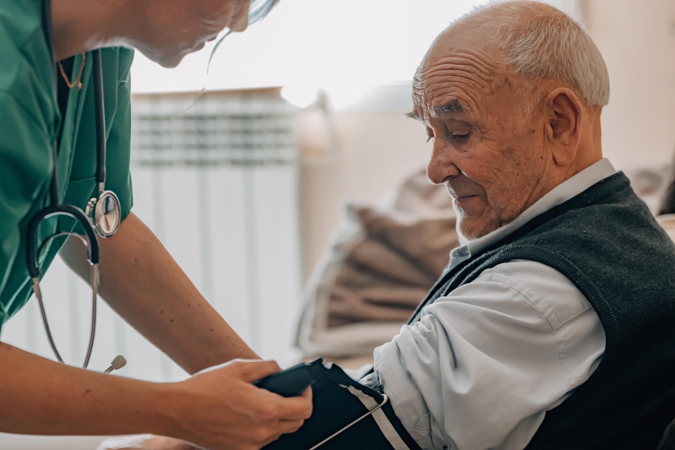 nurse taking residents blood pressure