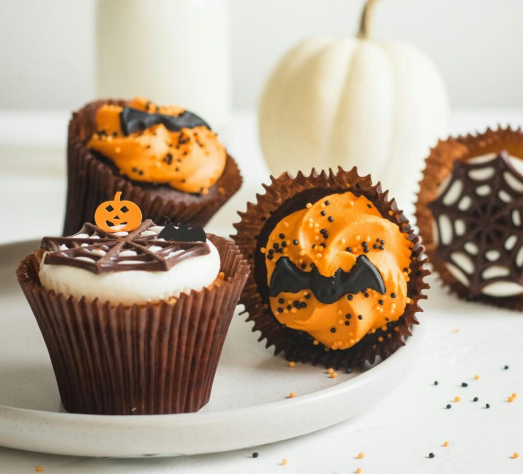 cupcakes decorated with halloween cobwebs and bats